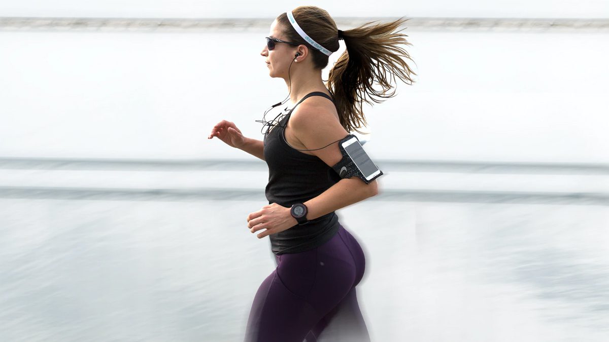 A Girl Jogging With A Smartphone pedometer app
